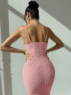 Elegant and romantic long dress for ladies with thin shoulder straps, a cinched waist and a slim figure, made of textured fabric